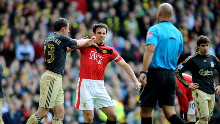 Jamie Carragher (L) of Liverpool argues with Gary Neville of Manchester United after United were awarded a penalty in the  first half, March 2010