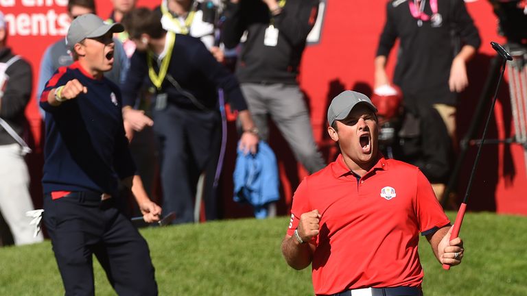 Team USA Patrick Reed (R) reacts with teammate Jordan Spieth after winning their match against Team Europe Justin Rose and Henrik Stenson on the 16th green