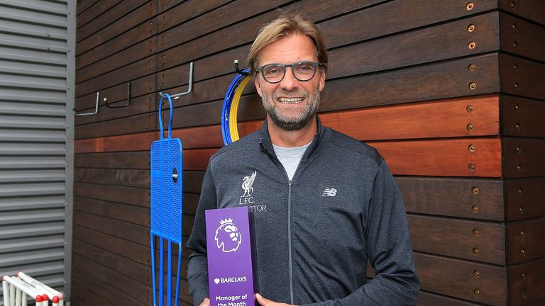 Jurgen Klopp poses with the Premier League manager of the month award for September at Liverpool's Melwood Training Ground