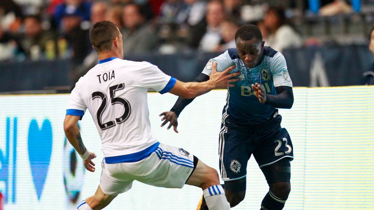 Kekuta Manneh of the Vancouver Whitecaps takes on Montreal Impact's Donny Toia