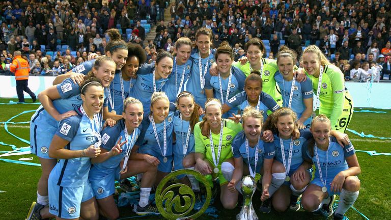 The Manchester City team poses with the Super League 1 and Continental Cup trophies won this season