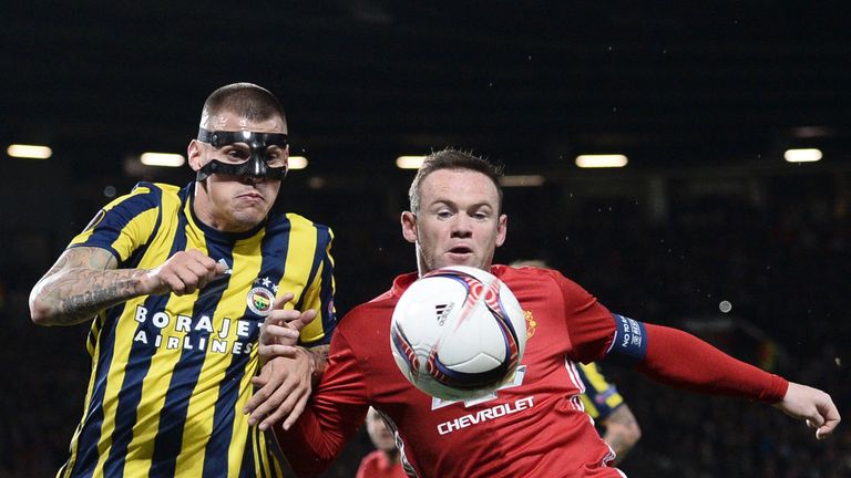Martin Skrtel and Wayne Rooney chase the ball down