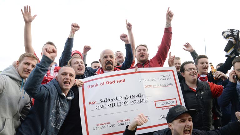 Salford Red Devils owner Marwan Koukash (centre)celebrates with the fans after his team's victory in the First Utility Super League, Million Pound Game at 