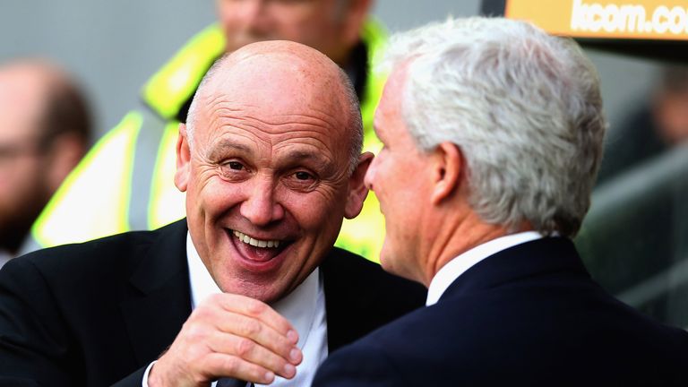 Mike Phelan smiles as he greets Mark Hughes