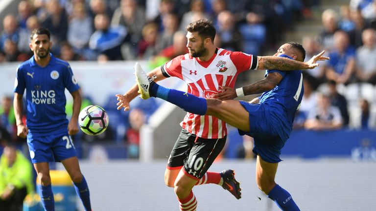 Charlie Austin battles for possession of the ball with Danny Simpson