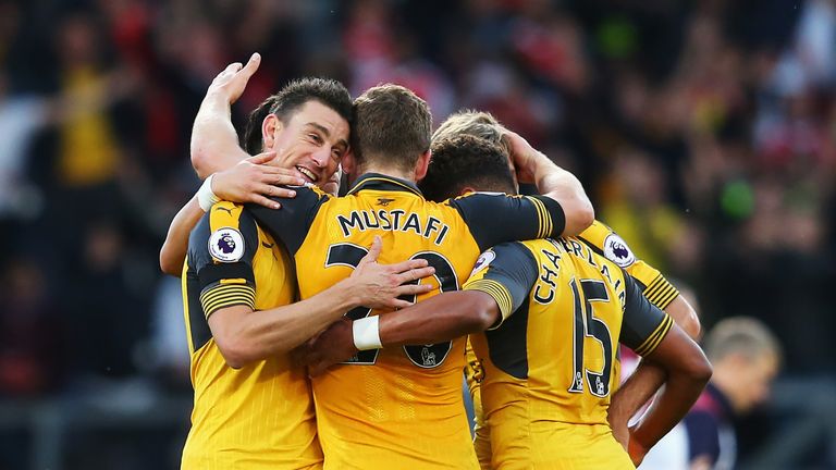 Laurent Koscielny celebrates Arsenal's match winning goal with his team-mates