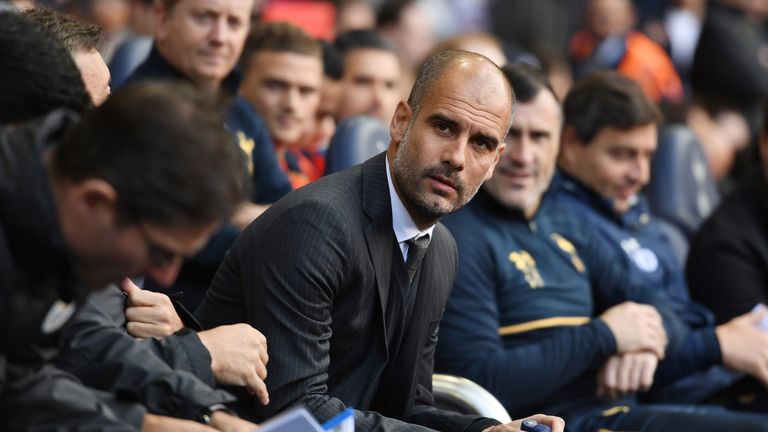 Pep Guardiola takes his seat on the away team bench prior to kick-off