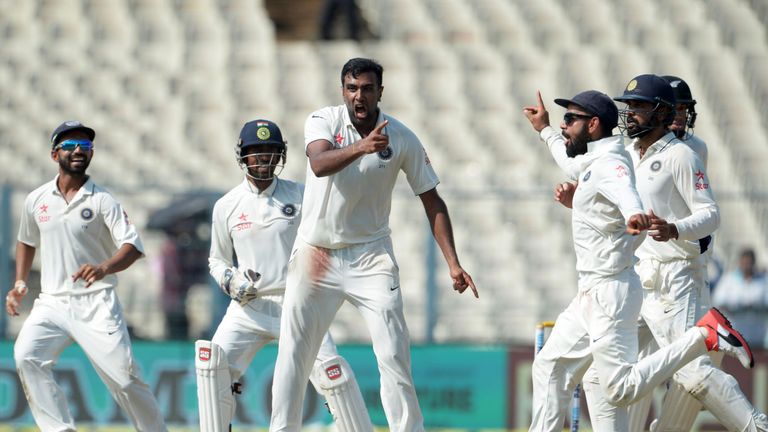 India's Ravichandran Ashwin(C) and captain Virat Kohli celebrate with teammates after the wicket of New Zealand's captain Ross Taylor
