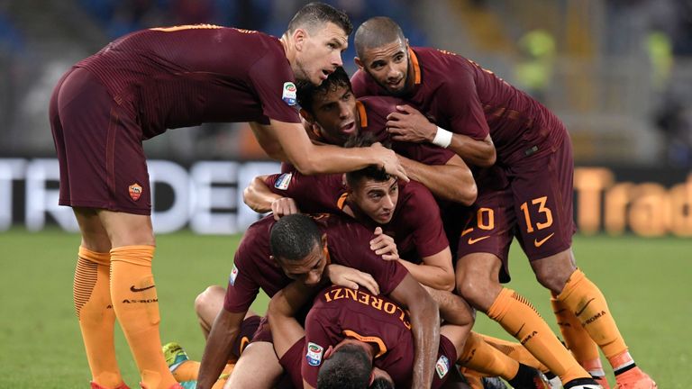 Roma's defender from Greece Kostas Manolas (bottom) celebrates with teammates after scoring during the Italian Serie A football match AS Roma vs Inter Mila