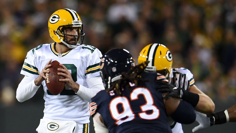 Quarterback Aaron Rodgers #12 of the Green Bay Packers drops back to pass against nose tackle Will Sutton #93 of the Chicago Bea
