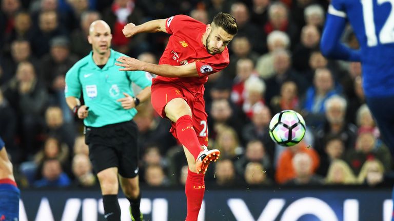 Adam Lallana hits a shot at goal in the second half of the game against Manchester United