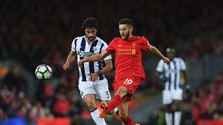 Liverpool's English midfielder Adam Lallana (R) plays the ball ahead of West Bromwich Albion's Argentinian midfielder Claudio Yacob (L) during the English 