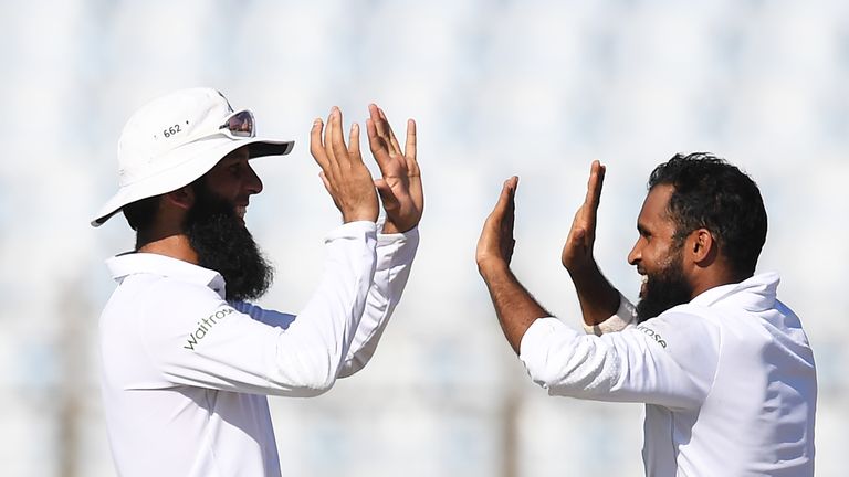England's Adil Rashid (R) and Moeen Ali celebrate the wicket of Bangladesh's Mahmudullah during the second day's play of the first Test