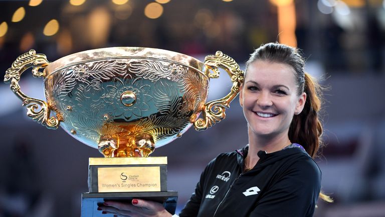 Agnieszka Radwanska of Poland poses with her trophy after beating Johanna Konta of Britain during the women's singles final of the China Open tennis tourna