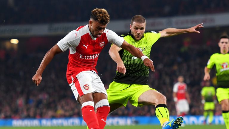 Alex Oxlade-Chamberlain of Arsenal (L) scores his side's first goal during the EFL Cup fourth round match between Arsenal and 