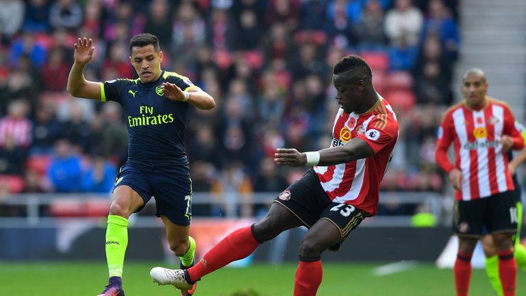 Alexis Sanchez of Arsenal and Lamine Kone of Sunderland compete for the ball 