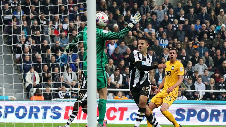 Aleksandar Mitrovic of Newcastle United (C) scores his sides first goal during the EFL Cup fourth round match 