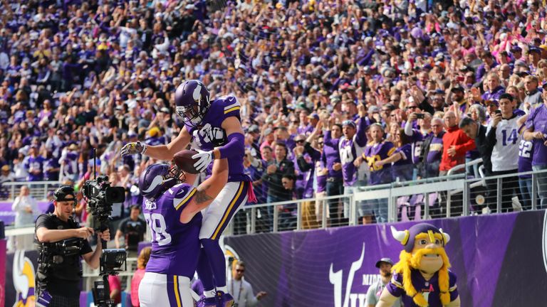 Jeremiah Sirles #78 lifts Adam Thielen #19 of the Minnesota Vikings in celebration of Thielen's touchdown