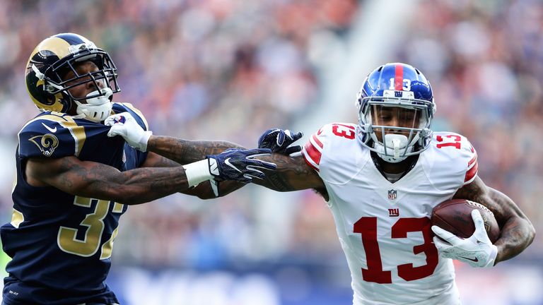 Odell Beckham Jr.  hands off Troy Hill during the NFL International Series match