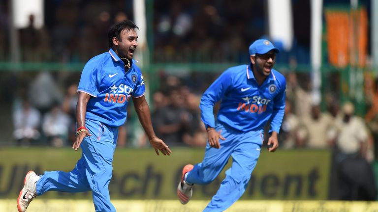 India's Amit Mishra (L) celebrates after bowling South Africa's Hashim Amla during the first ODI