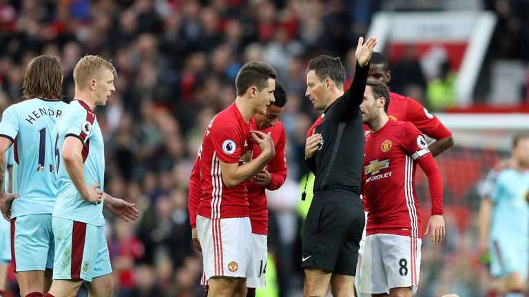 Ander Herrera protests to referee Mark Clattenburg after his red card