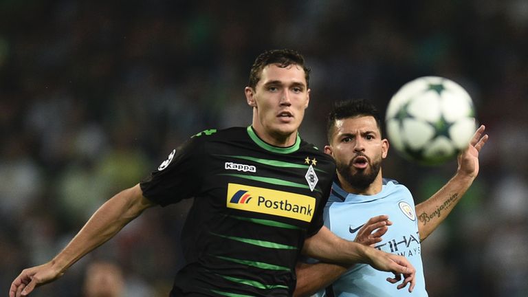 Moenchengladbach's Danish defender Andreas Christensen (L) and Manchester City's Argentinian striker Sergio Aguero (R) chase the ball during the UEFA Champ