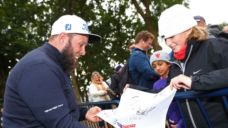 WATFORD, ENGLAND - OCTOBER 14:  Andrew Johnston of England signs an autograph for a young fan following the second round of the British Masters at The Grov