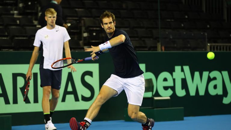 Andy Murray of Great Britain in action watched by team-mate Kyle Edmund