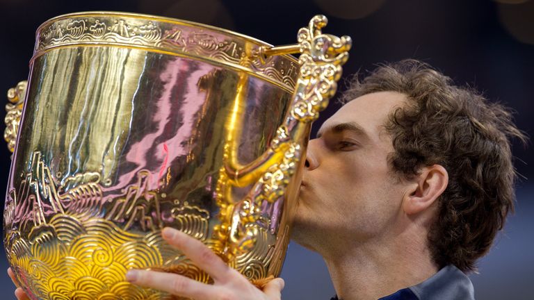 Andy Murray celebrates with the trophy as he wins against Grigor Dimitrov in their men's singles final match of the China Open