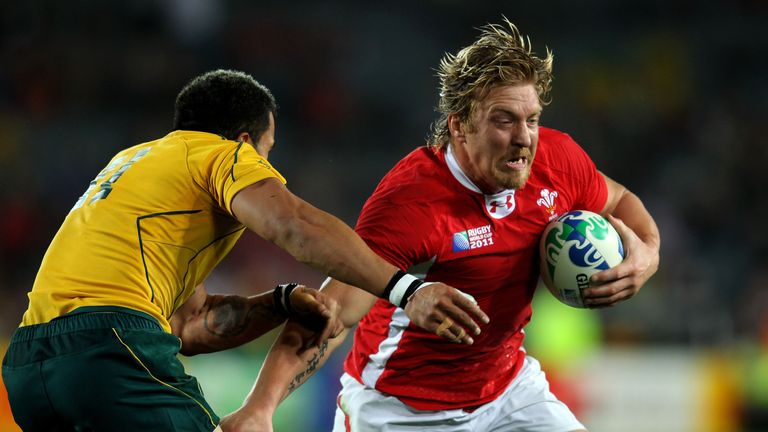 AUCKLAND, NEW ZEALAND - OCTOBER 21:  Andy Powell of Wales hands off Digby Ioane of the Wallabies during the 2011 IRB Rugby World Cup bronze final match bet