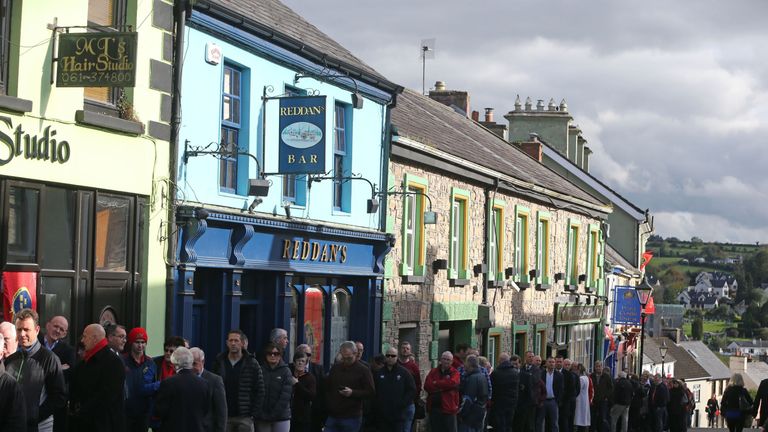 People wait in line to view the coffin of Munster Rugby head coach Anthony Foley in repose in St. Flannan's Church, Killaloe in Co Clare, ahead off his fun