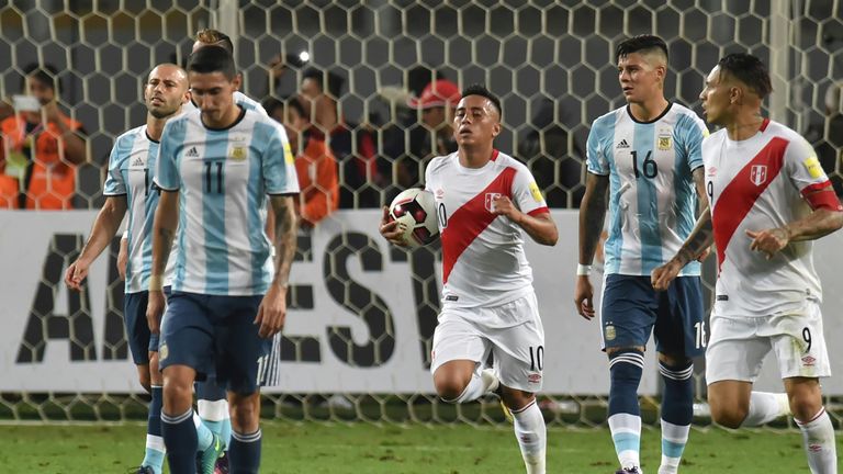 Peru's forward Christian Cueva (C) runs next to teammate Paolo Guerrero (R) after scoring a penalty against Argentina during their Russia 2018 World Cup fo