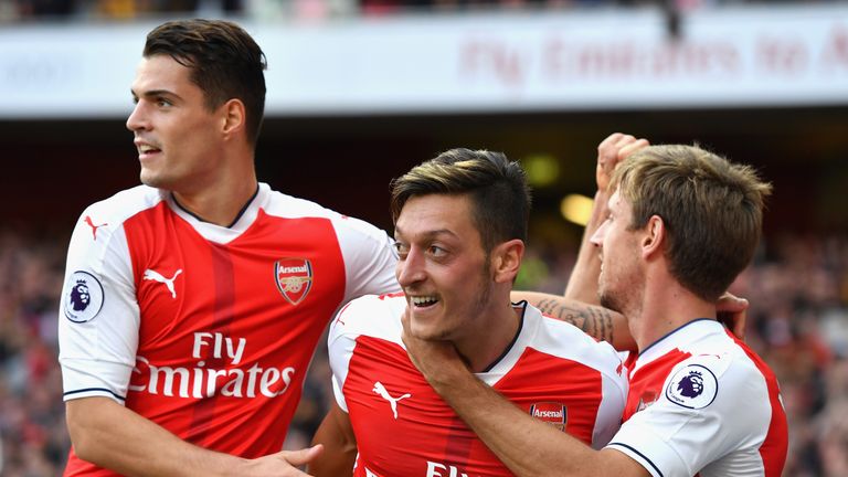LONDON, ENGLAND - OCTOBER 15: Mesut Ozil of Arsenal (C) celebrates scoring his sides third goal with his Arsenal team mates during the Premier League match
