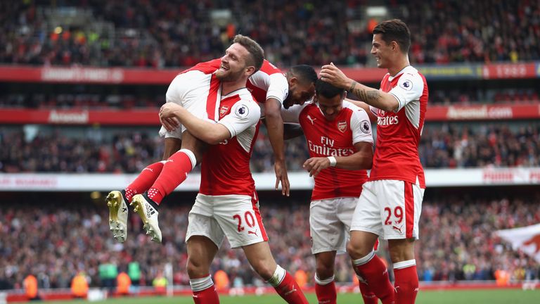 LONDON, ENGLAND - OCTOBER 15: Theo Walcott of Arsenal celebrates scoring his sides second goal with his Arsenal team mates during the Premier League match 