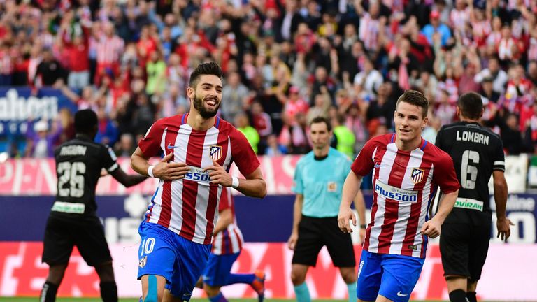 Atletico Madrid's Belgian midfielder Yannick Ferreira Carrasco (L) celebrates after scoring during the Spanish league football match Club Atletico de Madri