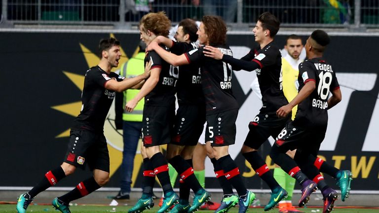Leverkusen players celebrate during their 2-1 win over Wolfsburg