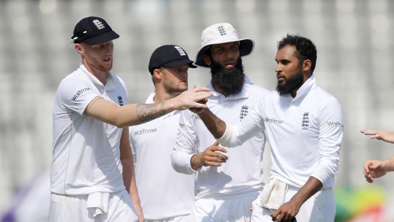 England's Adil Rashid (R) with teammates celebrates the wicket of Bangladesh Sabbir Rahman during the third day of the second Test match between Bangladesh