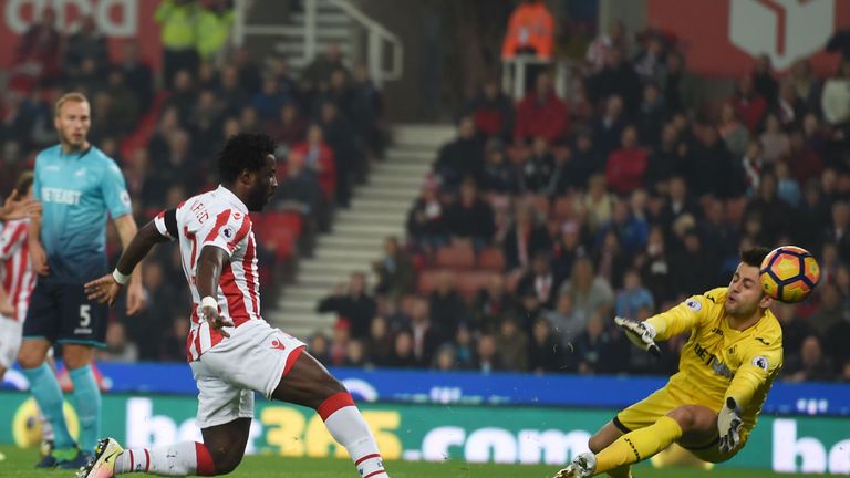 Stoke City's Ivorian striker Wilfried Bony (L) shoots and scores past Swansea City's Polish goalkeeper Lukasz Fabianski during the English Premier League f
