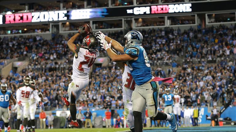 CHARLOTTE, NC - OCTOBER 10:  Brent Grimes #24 of the Tampa Bay Buccaneers intercepts a pass intended for Greg Olsen #88 of the Carolina Panthers late in th