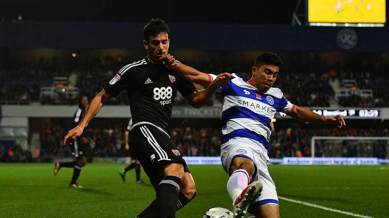 Maxime Colin of Brentford (L) battles for the ball with Massimo Luongo of Queens Park Rangers during the Sky Bet Championsh