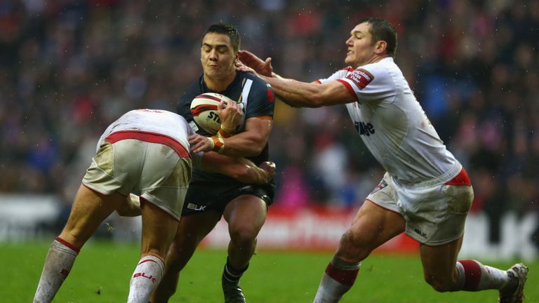 WIGAN, ENGLAND - NOVEMBER 14:  Kodi Nikorima (C) of New Zealand is held up by Gareth Widdop (L) and Brett Ferres (R) of England during the third Internatio