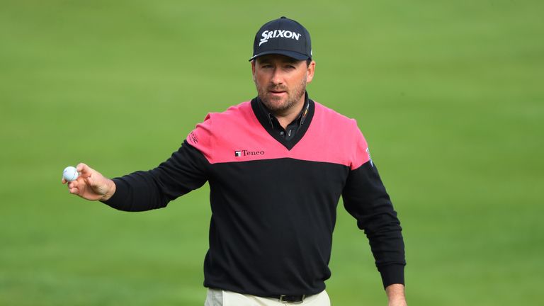 WATFORD, ENGLAND - OCTOBER 16:  Graeme McDowell of Northern Ireland acknowledges the crowd on the first green during the fourth round of the British Master