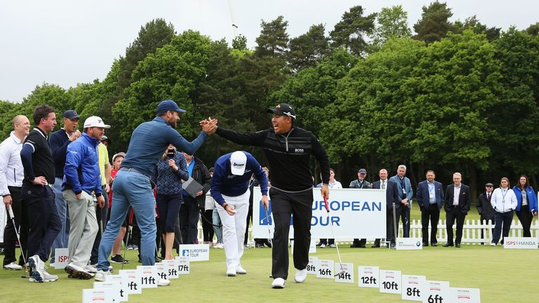 VIRGINIA WATER, ENGLAND - MAY 25:  Byeong Hun An of South Korea and Jamie Redknapp celebrate in the ISPS HANDA Pressure Putt Showdown prior to the BMW PGA 