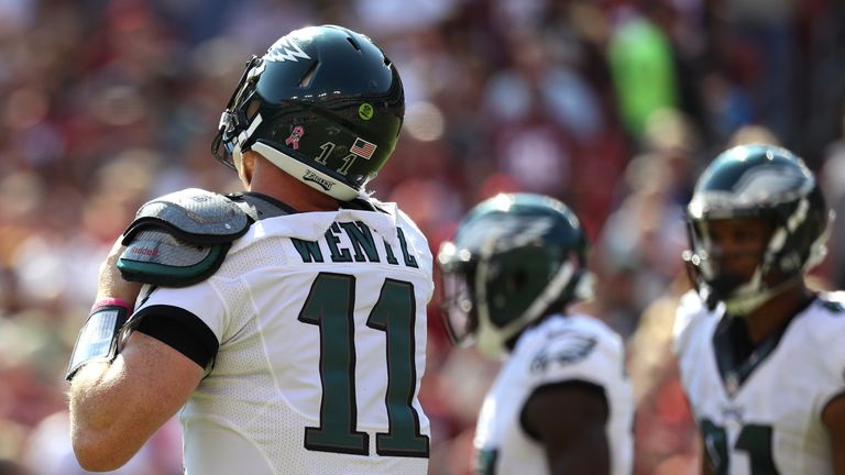 LANDOVER, MD - OCTOBER 16: Quarterback Carson Wentz #11 of the Philadelphia Eagles adjusts his equipment in the first quarter against the Washington Redski