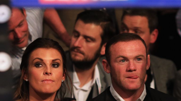 MANCHESTER, ENGLAND - SEPTEMBER 24:  Manchester United and England footballer Wayne Rooney (R) and wife Coleen look on from ringside at Manchester Arena on