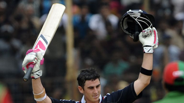 England cricketer Craig Kieswetter raises his bat and helmet as he celebrates after scoring a century during the third ODI