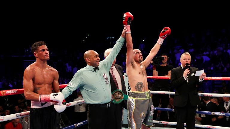 BIRMINGHAM, ENGLAND - OCTOBER 22: Referee Ian John Lewis holds aloft Craig Cunningham Of England arm after he stopped Anthony Ogogo Of England in the 8th R