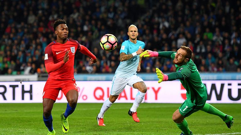 Jan Oblak of Slovenia dives for the ball under pressure from Daniel Sturridge