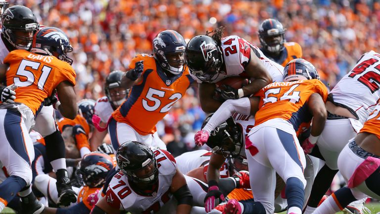 DENVER, CO - OCTOBER 9:  Running back Devonta Freeman #24 of the Atlanta Falcons dives for a touchdown in the first quarter of the game against the Denver 