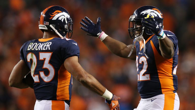 DENVER, CO - OCTOBER 24:  Running back Devontae Booker #23 and running back C.J. Anderson #22 of the Denver Broncos celebrate a score in the second half of